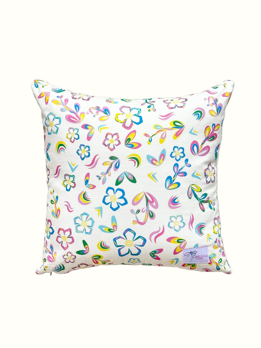 Decorative pillow with colourful floral and rainbow pattern on a white background