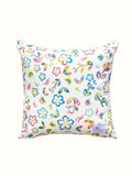 Decorative pillow with colourful floral and rainbow pattern on a white background