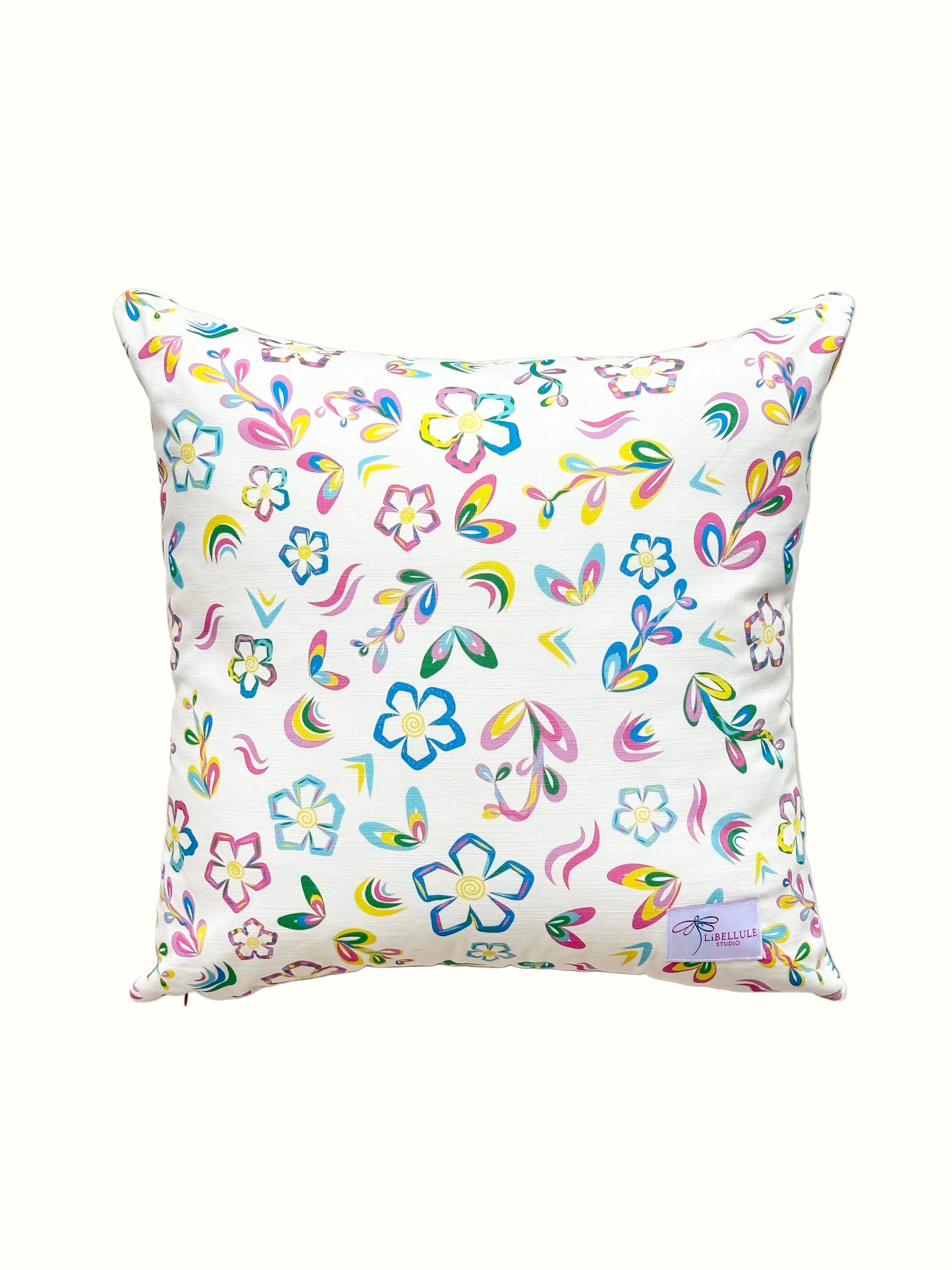 Decorative pillow with colourful floral and rainbow pattern on a white background