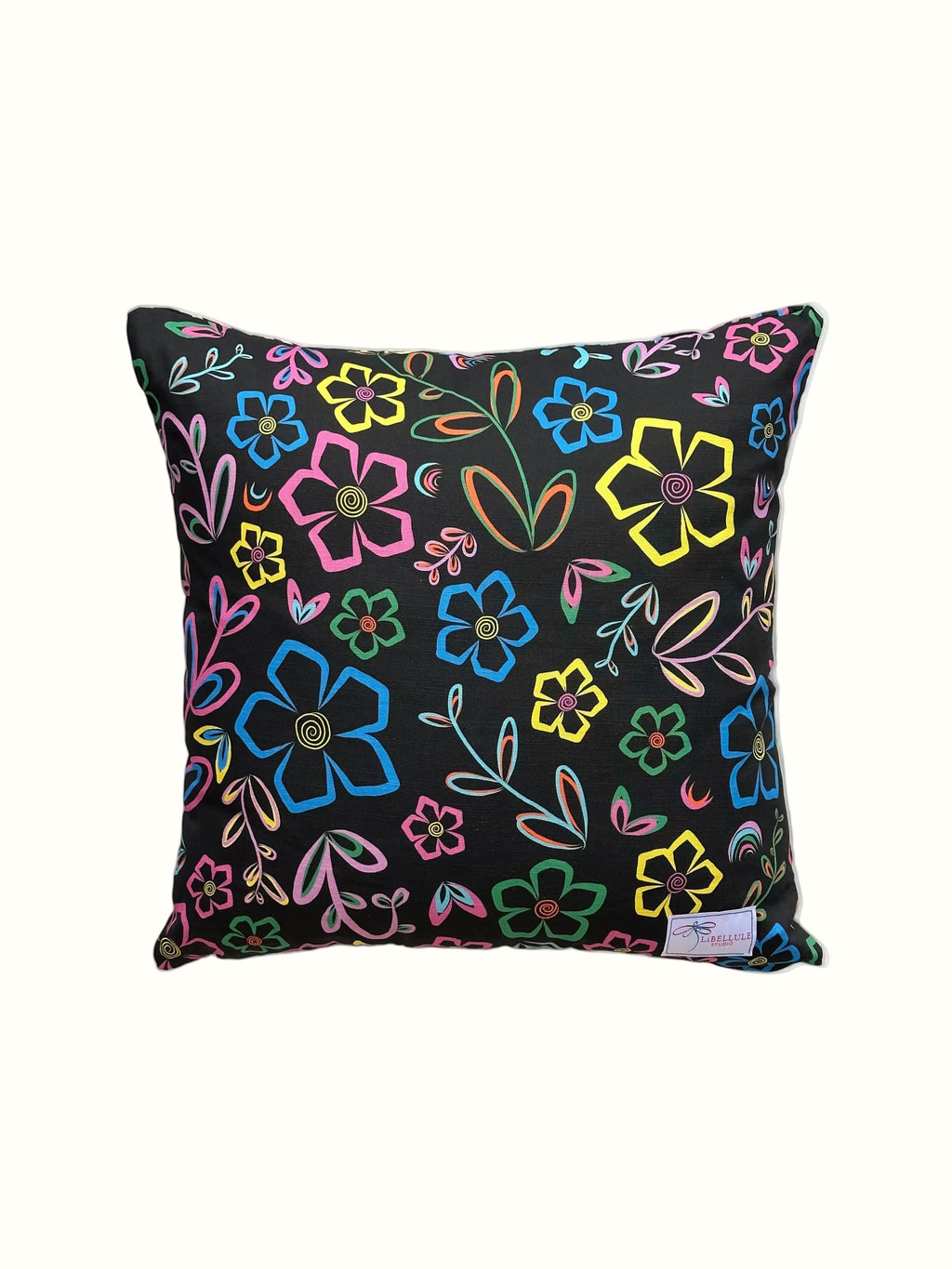 A square throw pillow with a black background and a vibrant, multicolored floral pattern, shown against a plain off-white background.