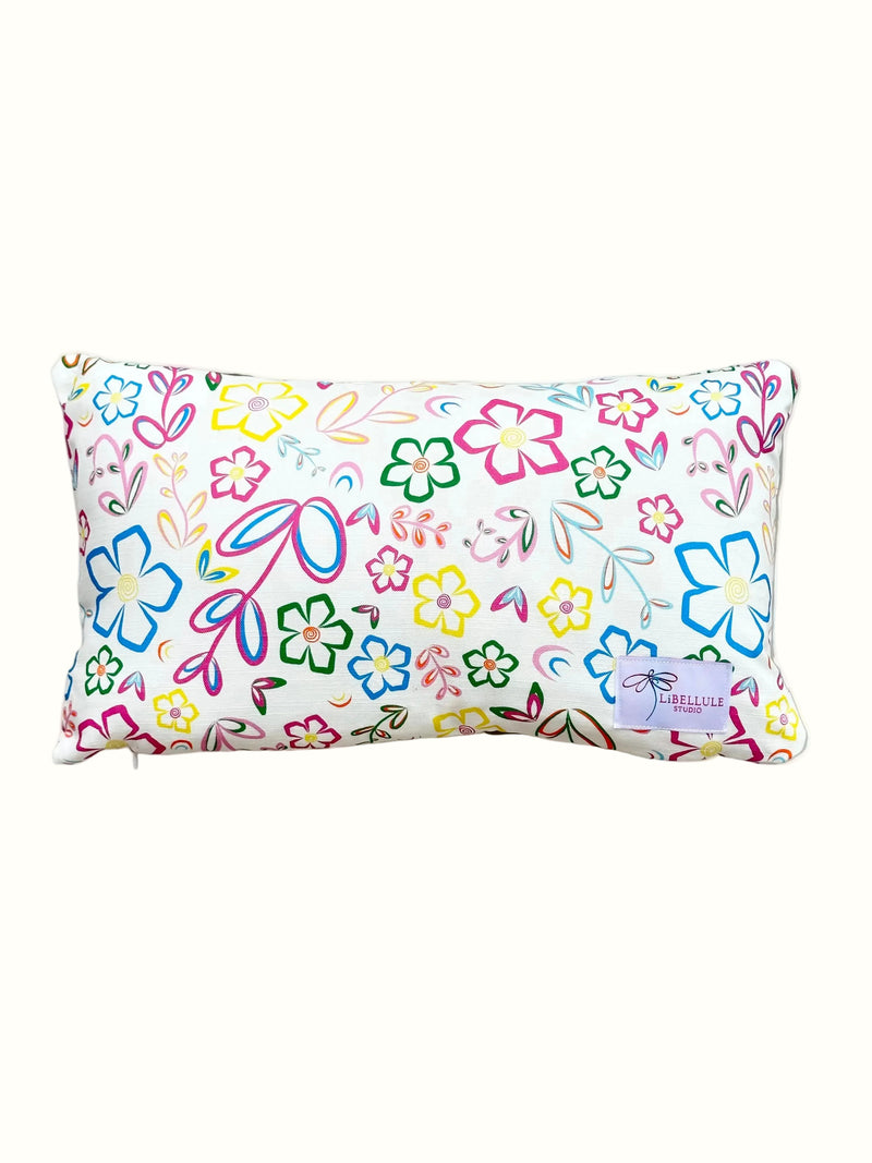 Floral-patterned pillow with colorful designs on a white background